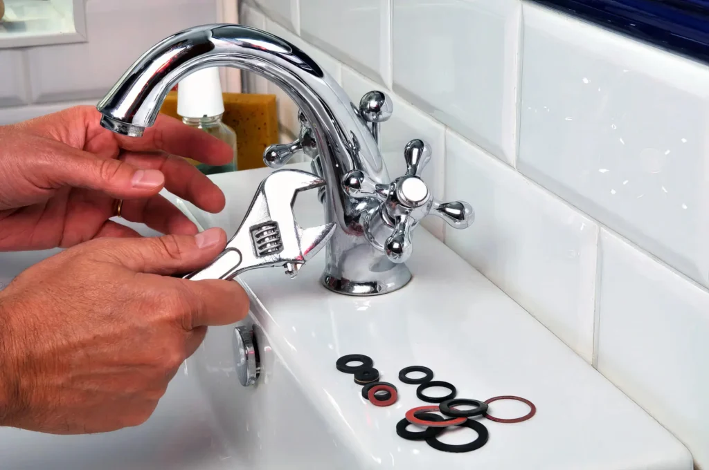 Plumber performing maintenance on a bathroom faucet in Spring Hill