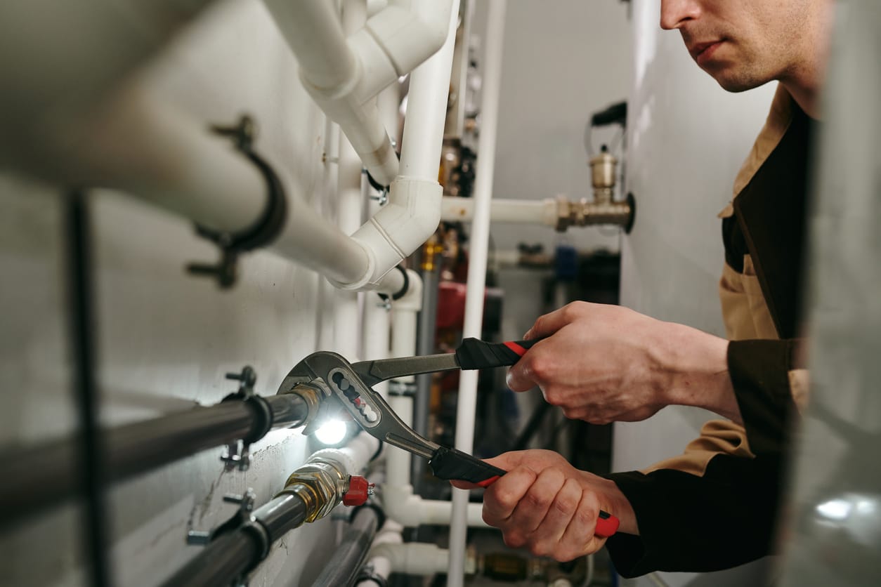 Plumbers maintaining commercial plumbing pipes in Spring Hill