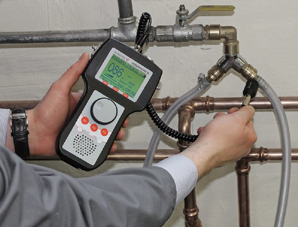 Plumber testing pipes with electronic leak detection equipment in Spring Hill