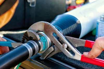Technician tightening an industrial pipe connection in Spring Hill