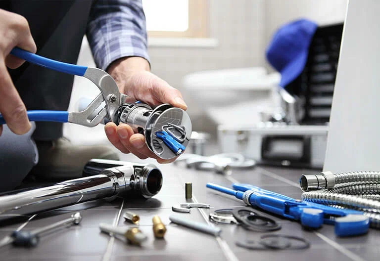 Technician repairing a plumbing fixture with professional tools in Spring Hill