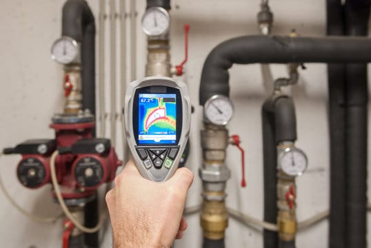 Plumber using a thermal imaging camera to inspect pipes in Spring Hill