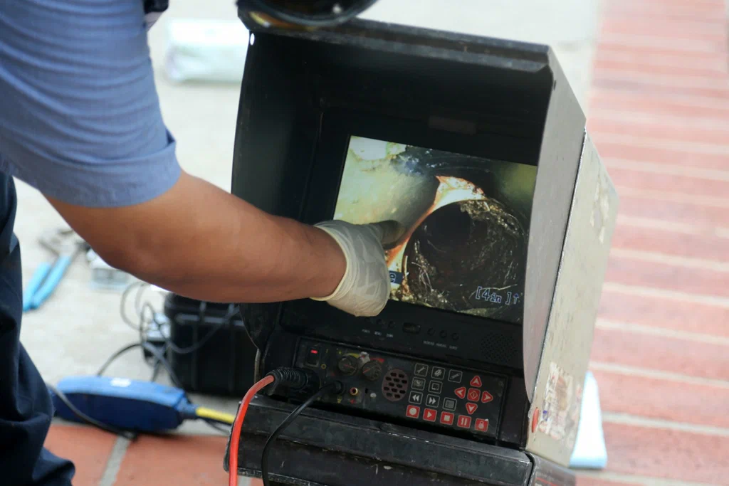 Technician viewing a drain inspection camera in Spring Hill
