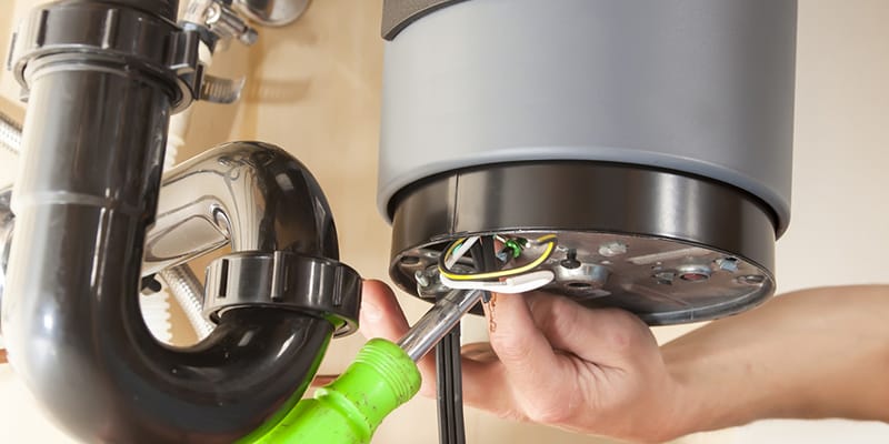 Technician repairing the heating element of a water heater in Spring Hill