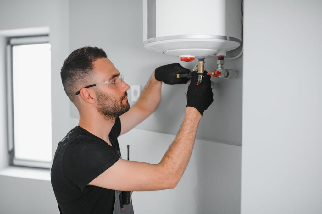 Technician performing water heater maintenance in Spring Hill